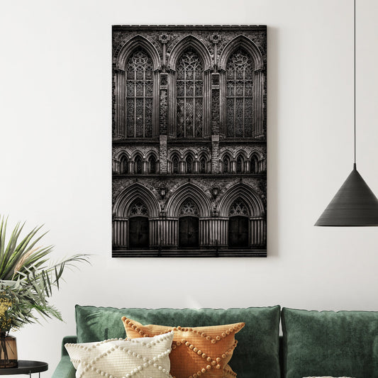 black and white photo of gothic church façade with stained glass windows and arched doors