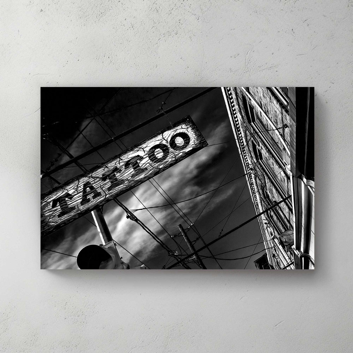 black and white photo of tattoo parlour storefront with neon signs and urban street details