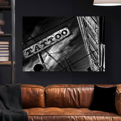 black and white photo of tattoo parlour storefront with neon signs and urban street details