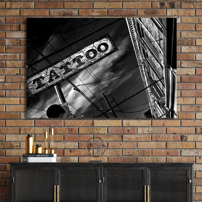 black and white photo of tattoo parlour storefront with neon signs and urban street details