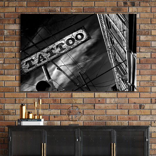 black and white photo of tattoo parlour storefront with neon signs and urban street details