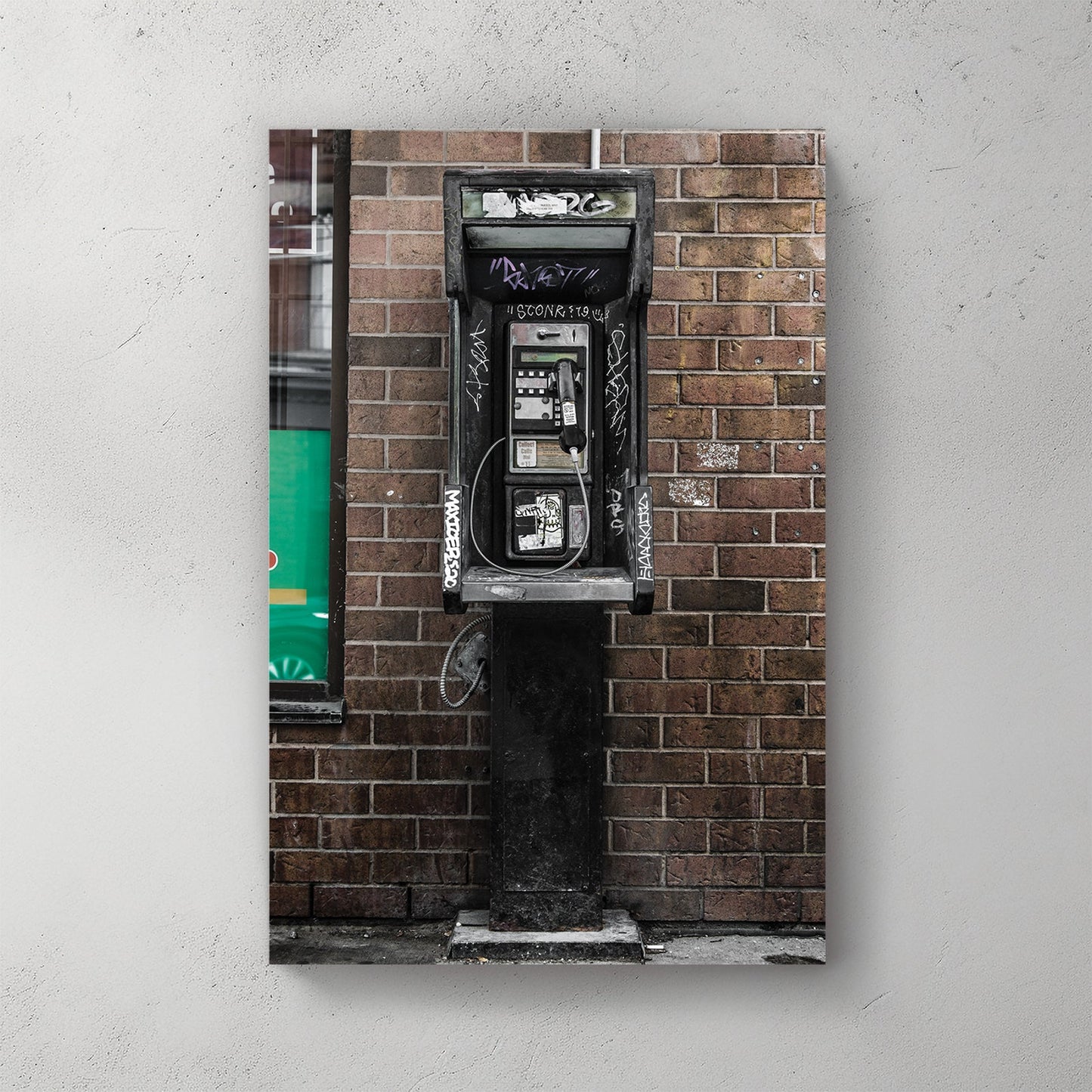 gritty urban phone booth wall art with graffiti and brick wall
