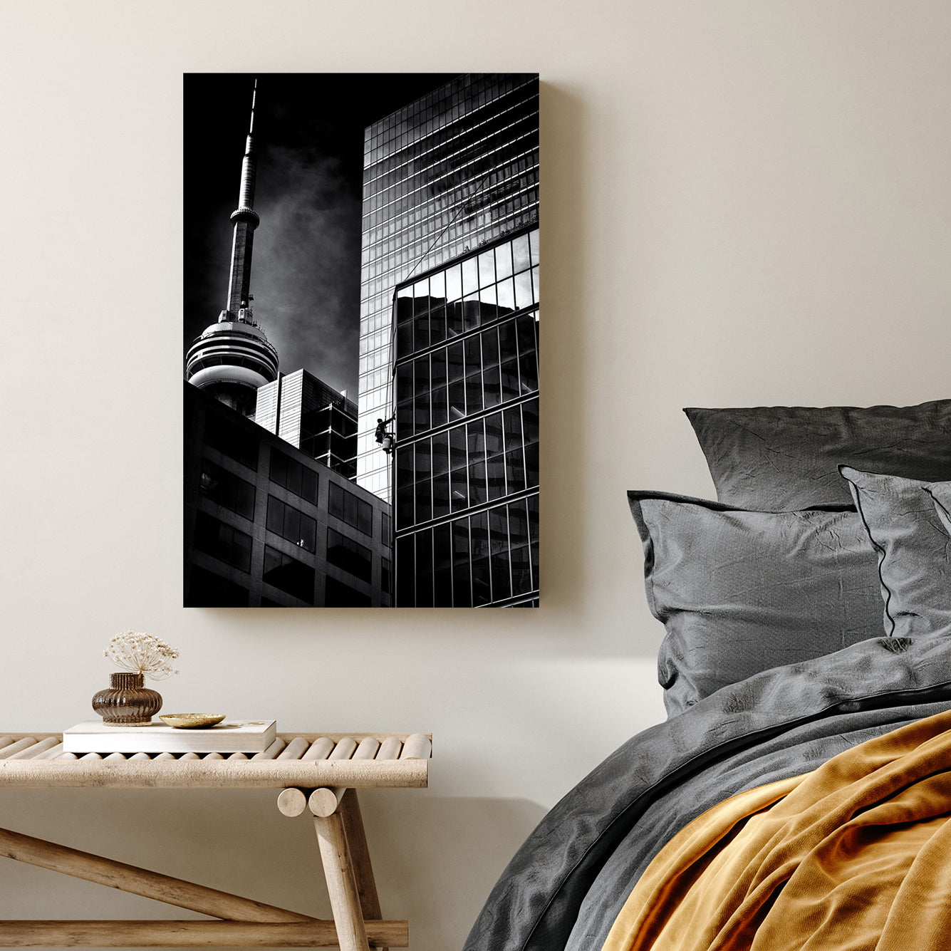 black and white photo of CN Tower and window washer on Toronto skyscraper