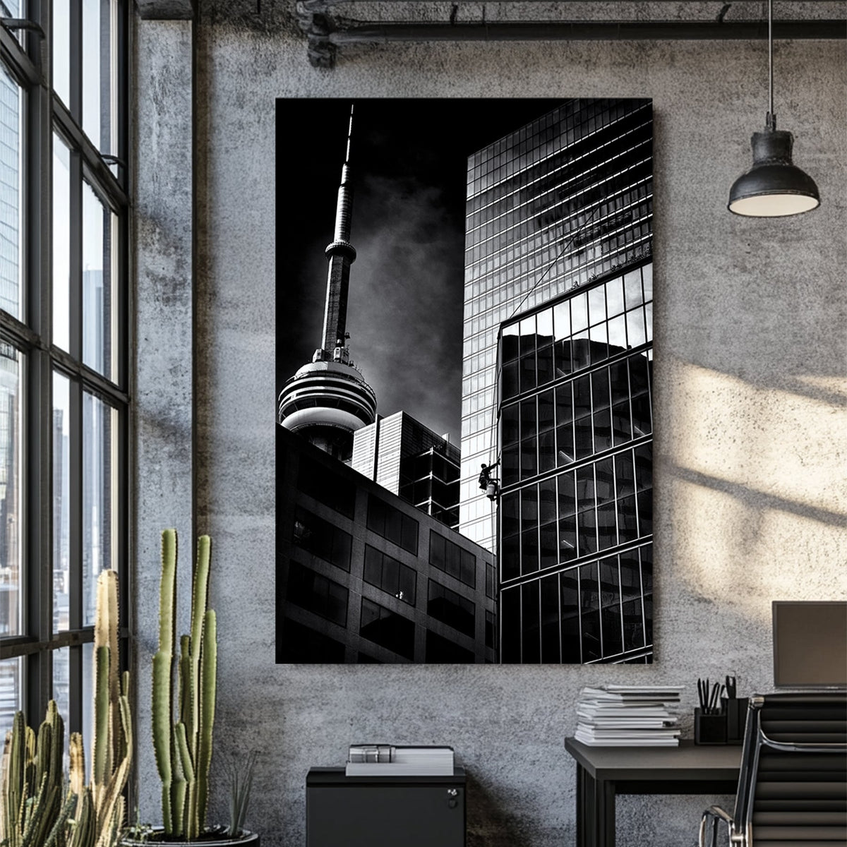 black and white photo of CN Tower and window washer on Toronto skyscraper