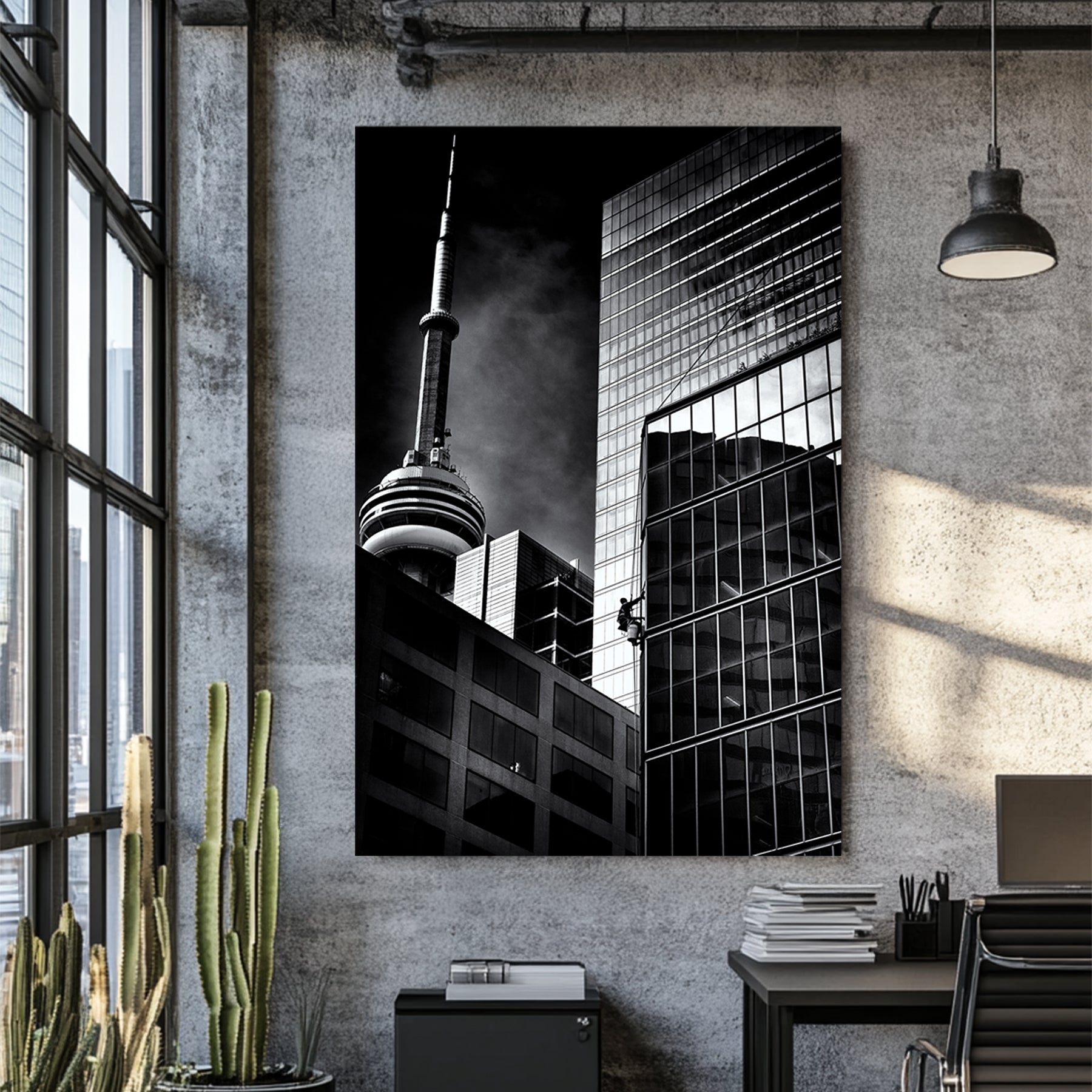 black and white photo of CN Tower and window washer on Toronto skyscraper