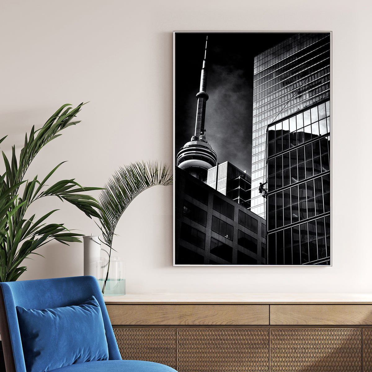 black and white photo of CN Tower and window washer on Toronto skyscraper