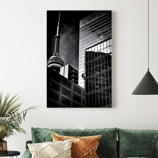 black and white photo of CN Tower and window washer on Toronto skyscraper