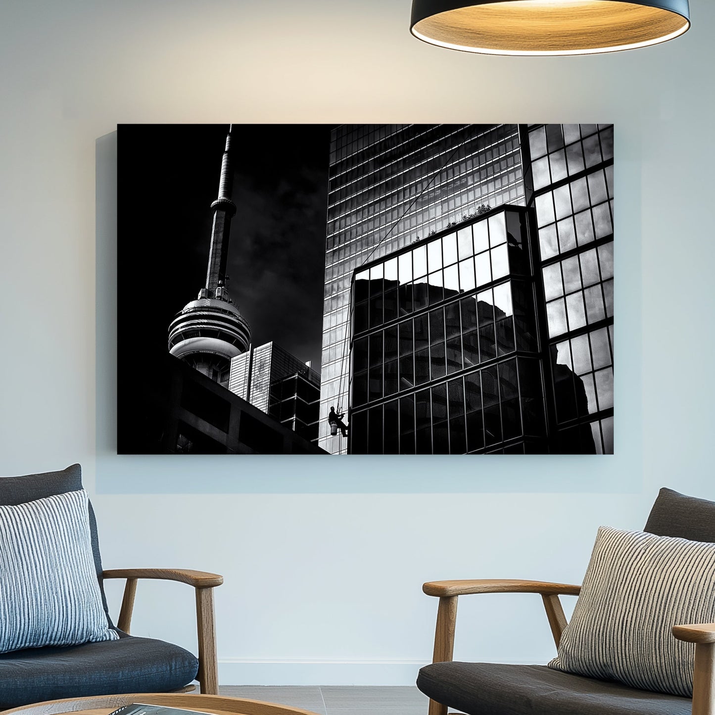 black and white Toronto photo with CN Tower and window washer on glass building