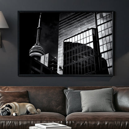 black and white Toronto photo with CN Tower and window washer on glass building