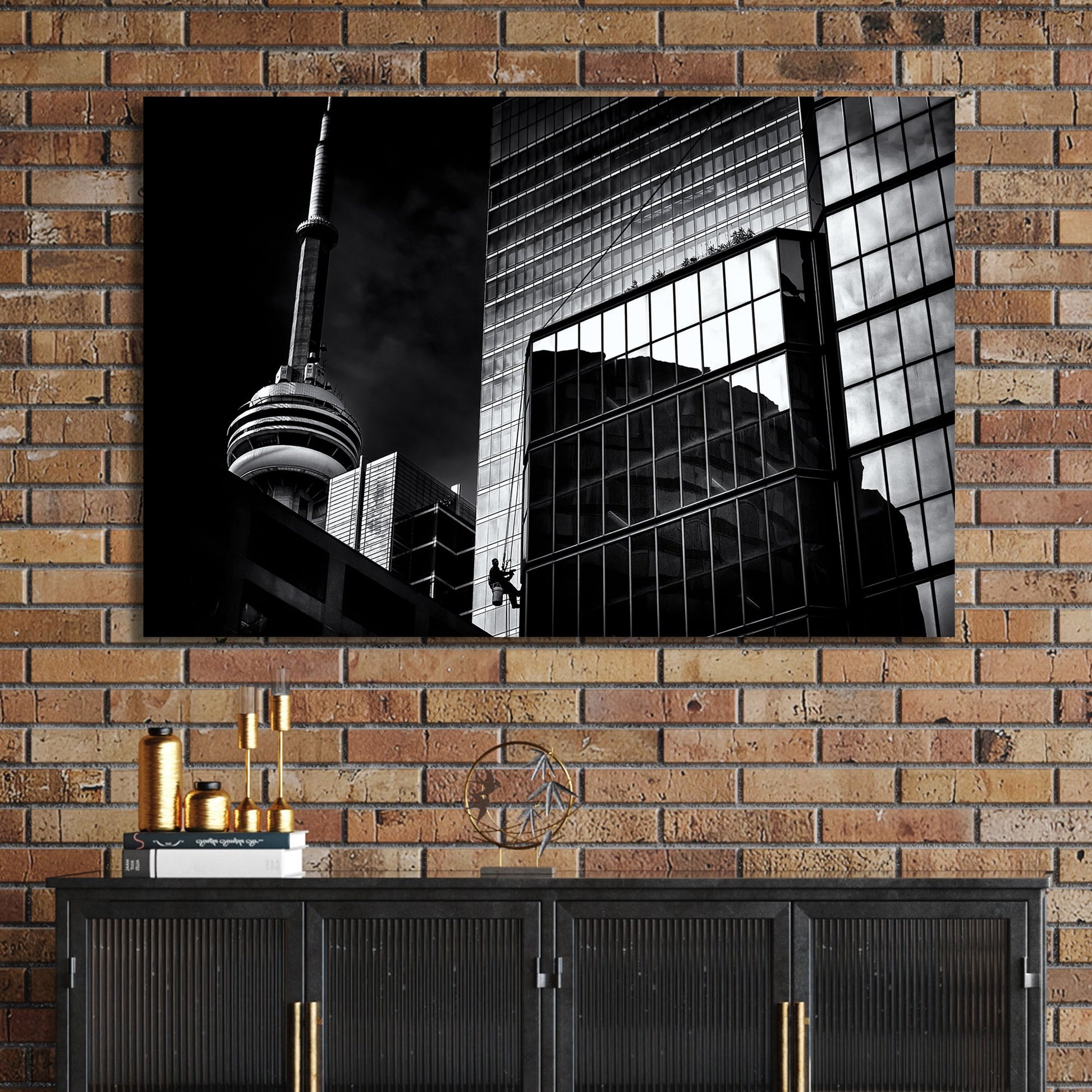 black and white Toronto photo with CN Tower and window washer on glass building