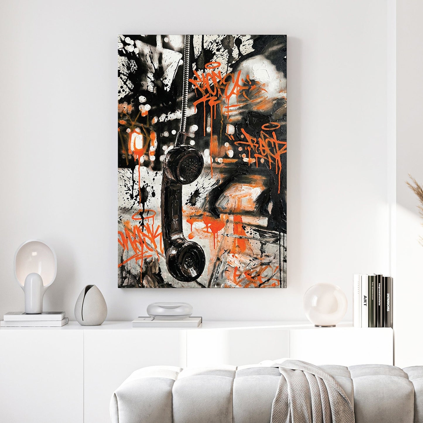 Vintage telephone handset wall art with orange graffiti tags and black marks.