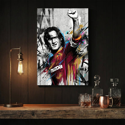 Francesco Totti street art wall art with raised fist and colourful urban drips.