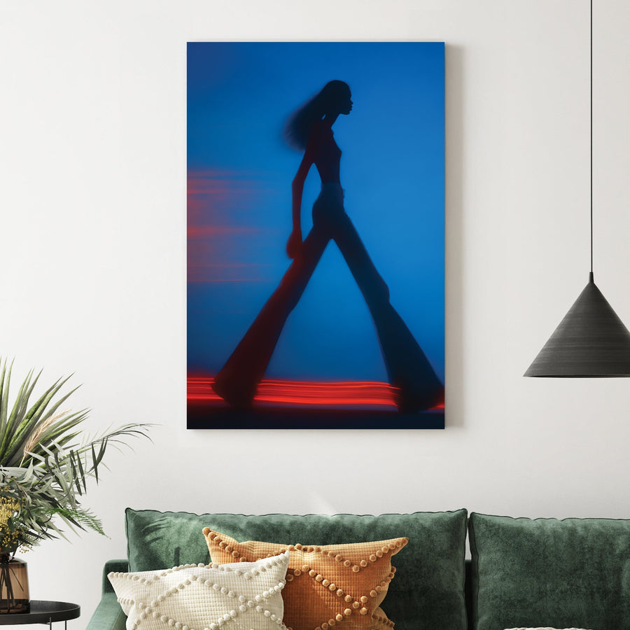 Blurred silhouette of a fashion model walking with red light trails wall art.