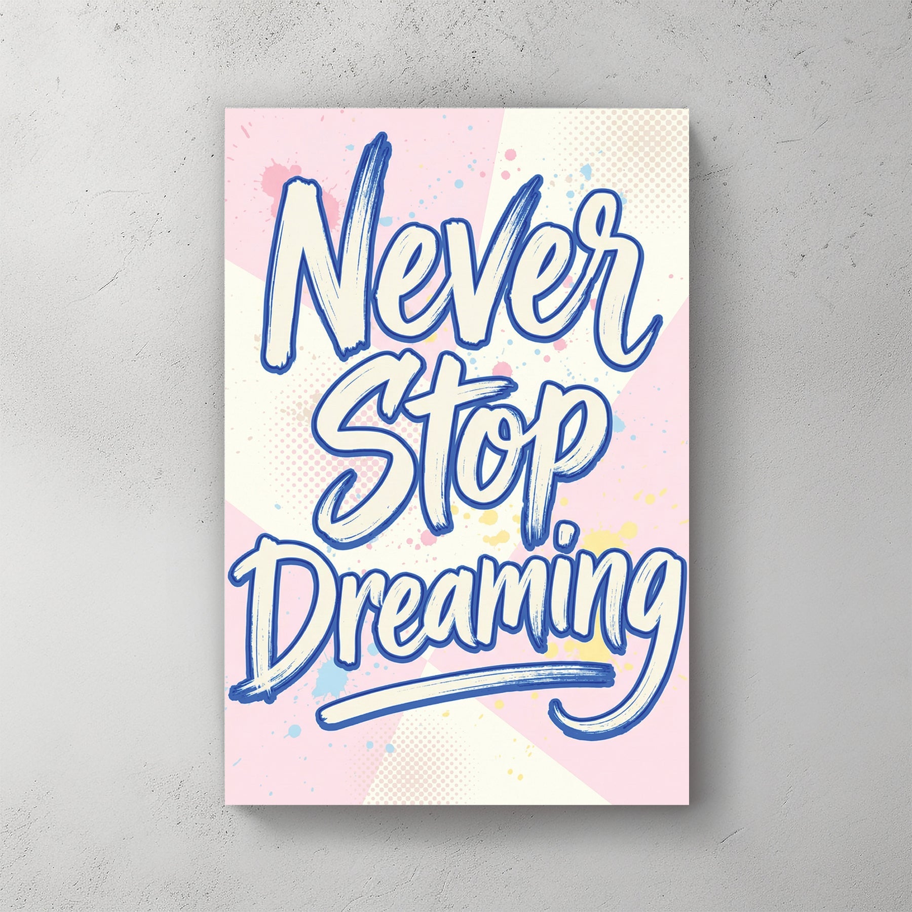 Blue Never Stop Dreaming typography wall art on pastel pink and yellow background.