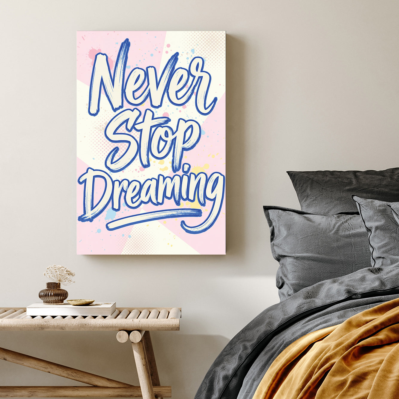Blue Never Stop Dreaming typography wall art on pastel pink and yellow background.