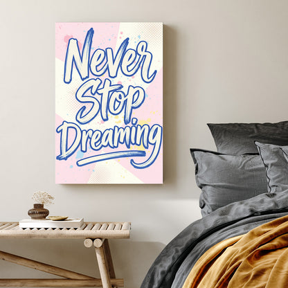 Blue Never Stop Dreaming typography wall art on pastel pink and yellow background.