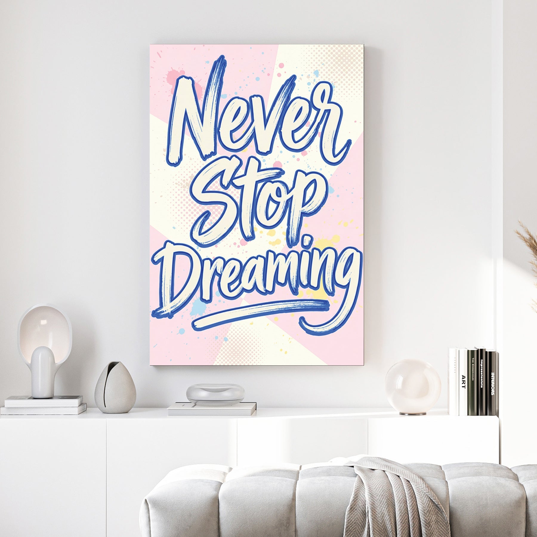 Blue Never Stop Dreaming typography wall art on pastel pink and yellow background.