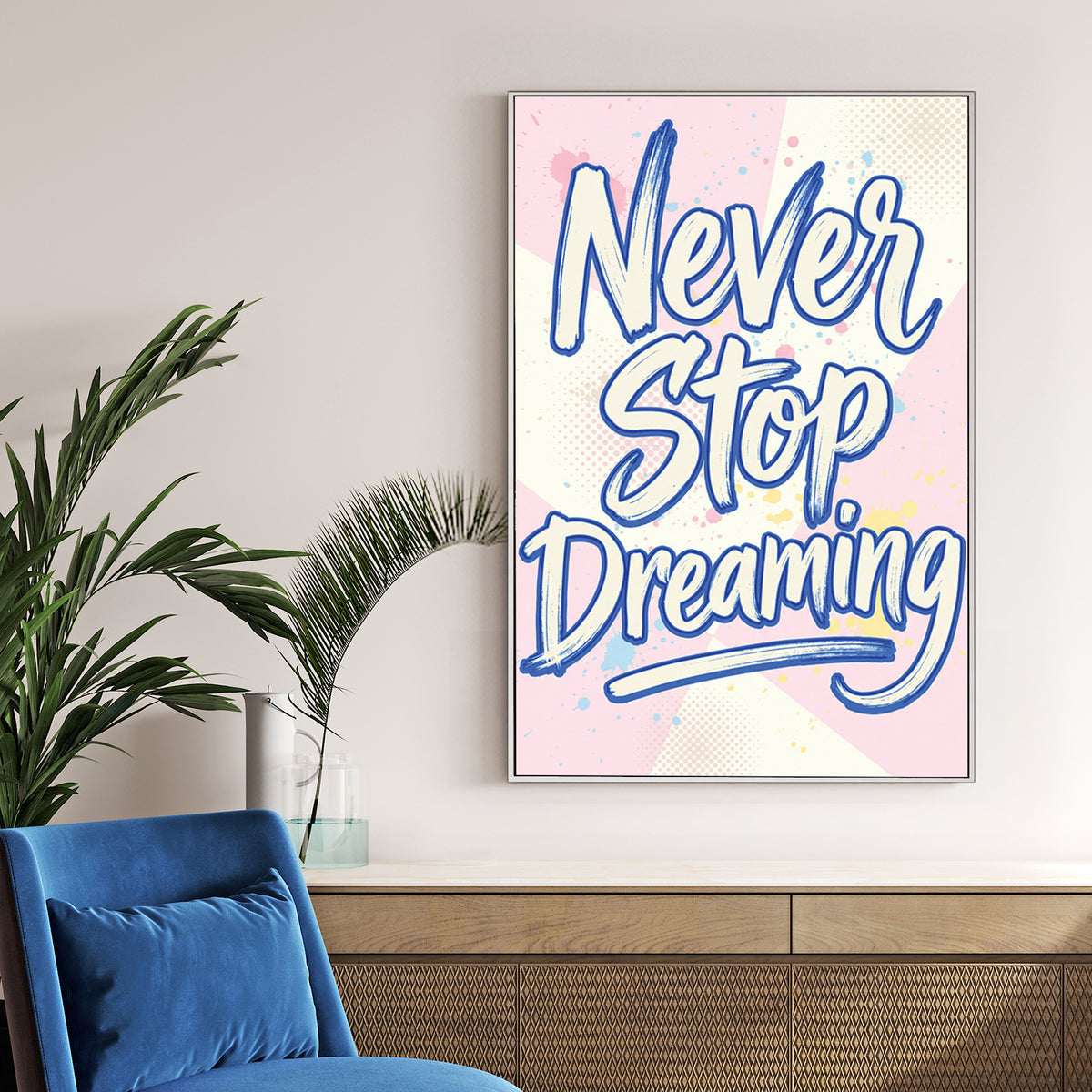 Blue Never Stop Dreaming typography wall art on pastel pink and yellow background.