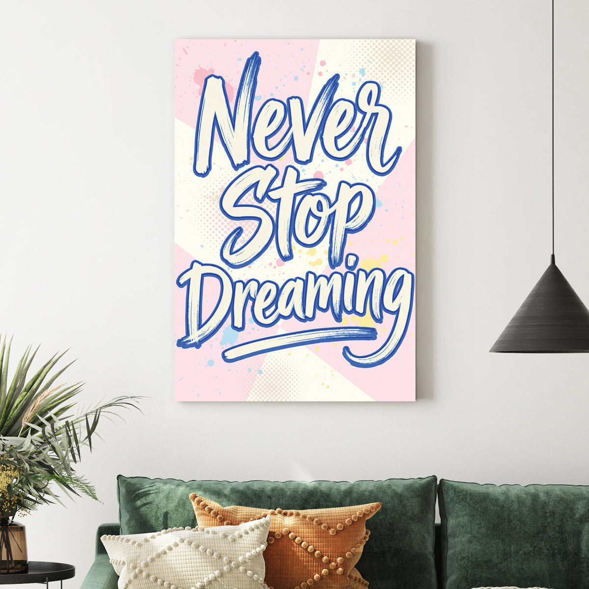 Blue Never Stop Dreaming typography wall art on pastel pink and yellow background.