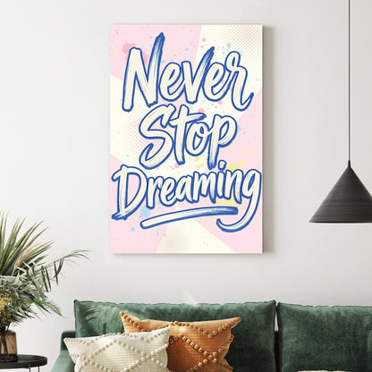 Blue Never Stop Dreaming typography wall art on pastel pink and yellow background.