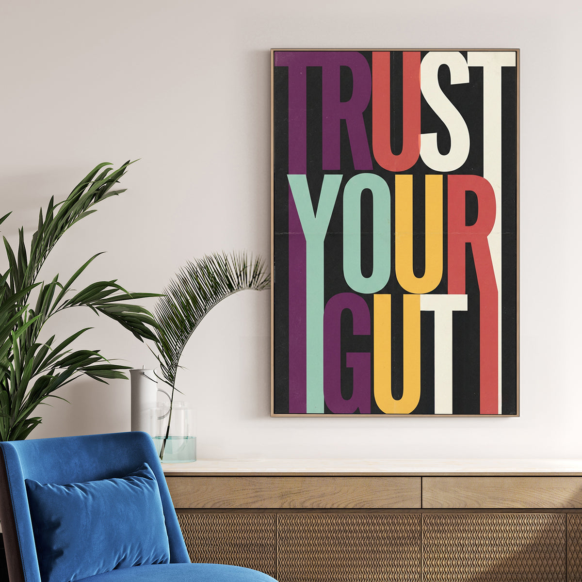 Modern Trust Your Gut typography wall art with colourful elongated letters on black background.
