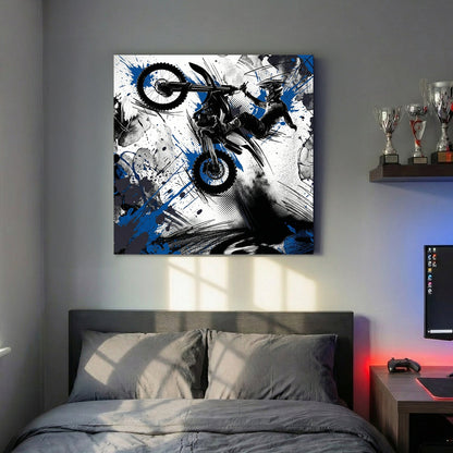 Motocross rider on bike in mid-jump with blue ink splatters and geometric design