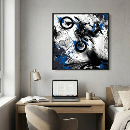 Motocross rider on bike in mid-jump with blue ink splatters and geometric design
