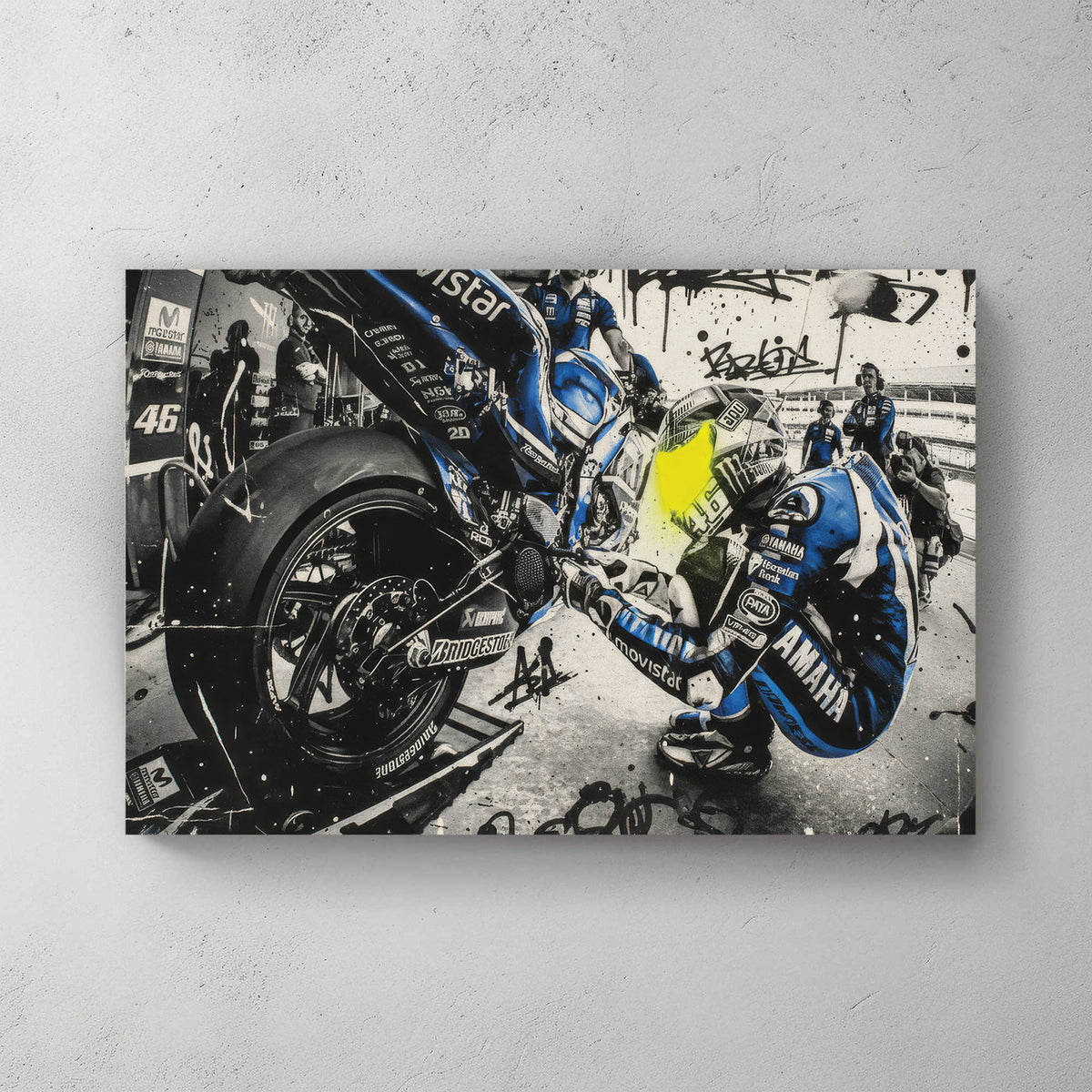 Valentino Rossi MotoGP pit stop scene, blue Movistar Yamaha leathers, mechanics swarming the bike, graffiti tags and splatter overlay — canvas wall art print
