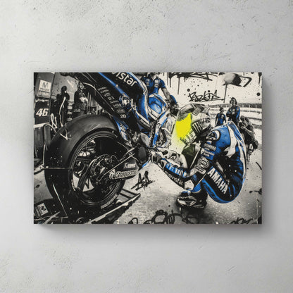 Valentino Rossi MotoGP pit stop scene, blue Movistar Yamaha leathers, mechanics swarming the bike, graffiti tags and splatter overlay — canvas wall art print