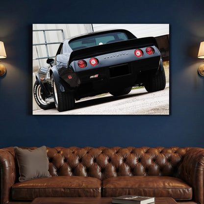 Black Corvette Stingray Rear canvas wall art print above a sofa in a contemporary living room