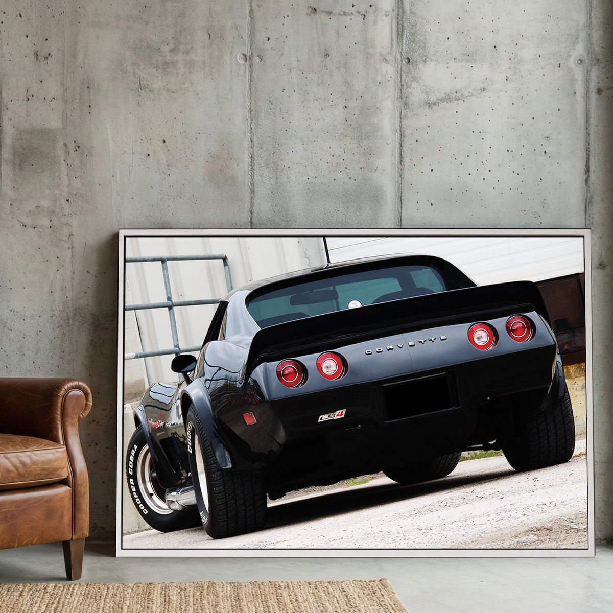Black Corvette Stingray Rear canvas wall art print displayed in a styled living room