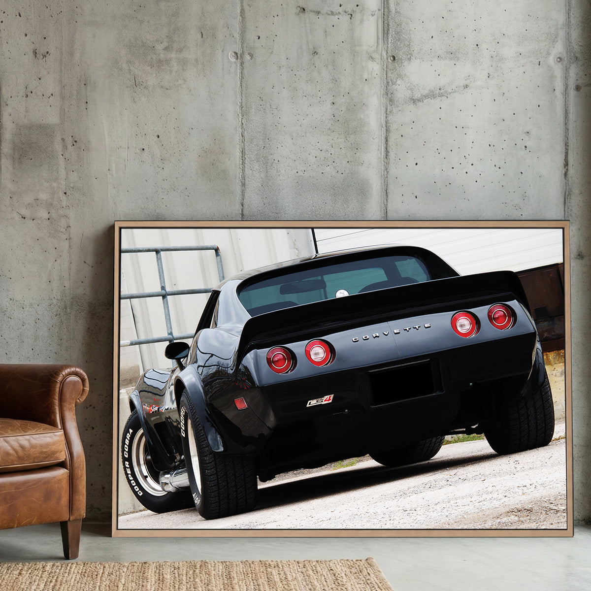 Black Corvette Stingray Rear canvas wall art print displayed in a styled living room