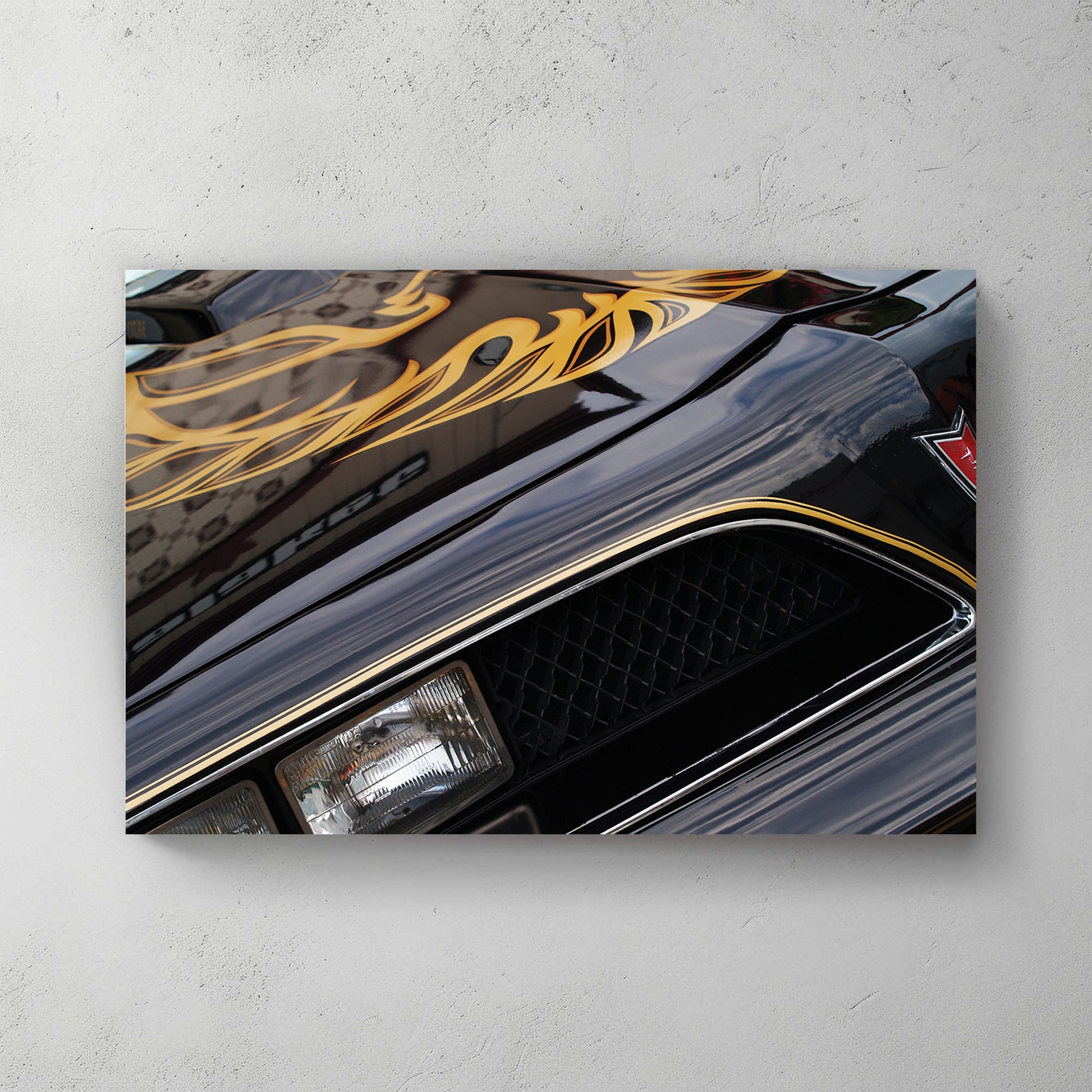 Black-and-gold Bandit Trans-Am, gold firebird wing across the hood, gold pinstripe, chrome headlight — canvas wall art print