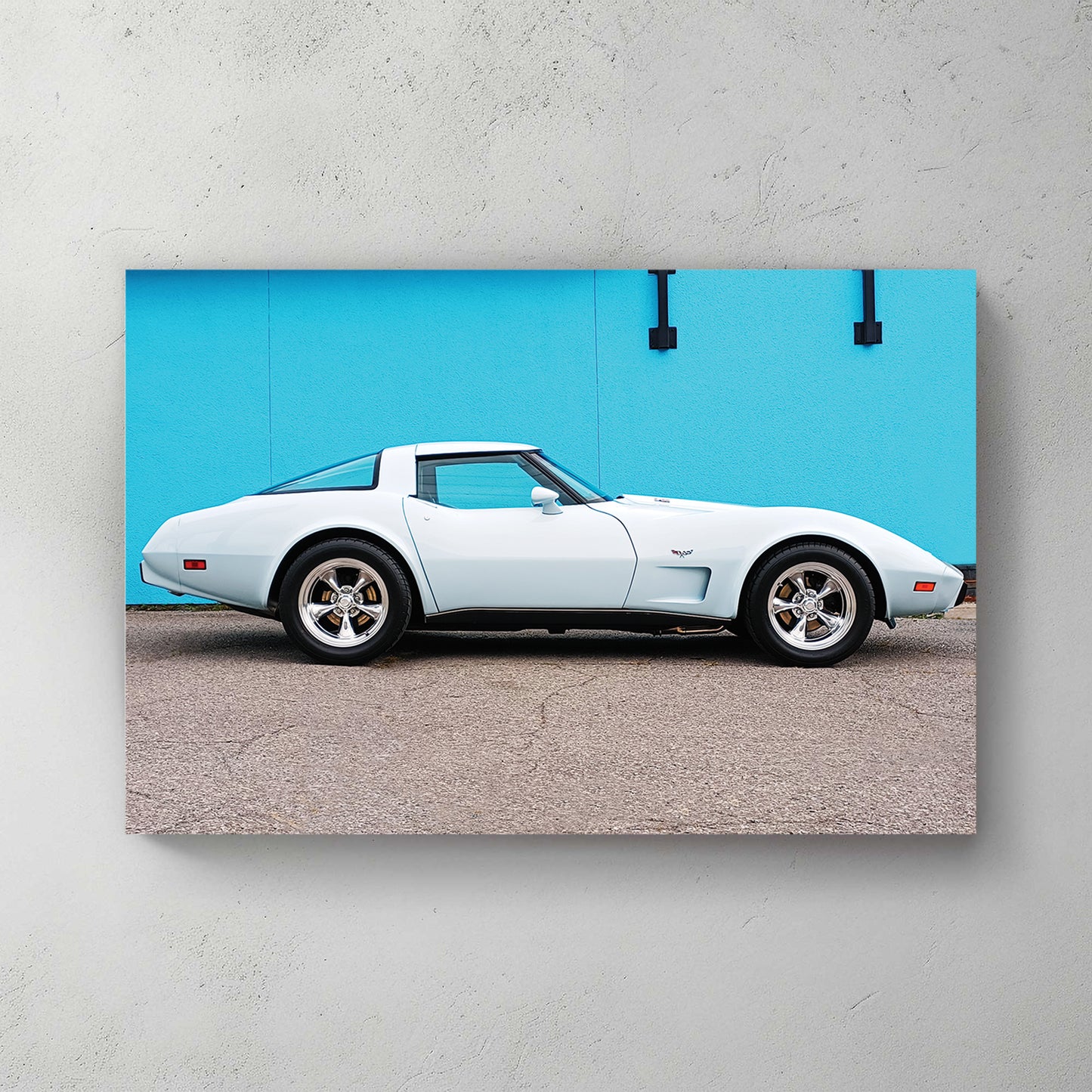 Pale ice-blue and white C3 Corvette side profile against a bright turquoise wall, chrome mag wheels — canvas wall art print