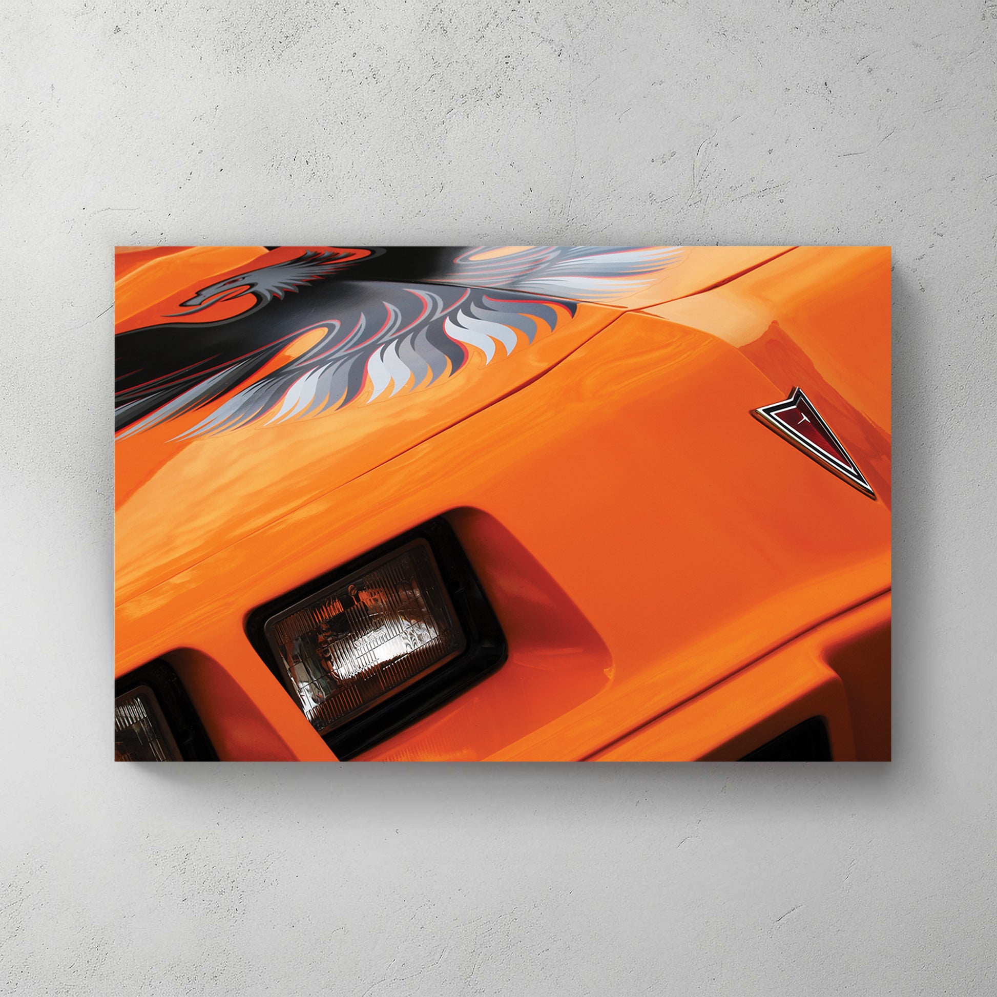 Bright orange Trans-Am hood firebird decal with Pontiac arrowhead badge and quad headlights — canvas wall art print