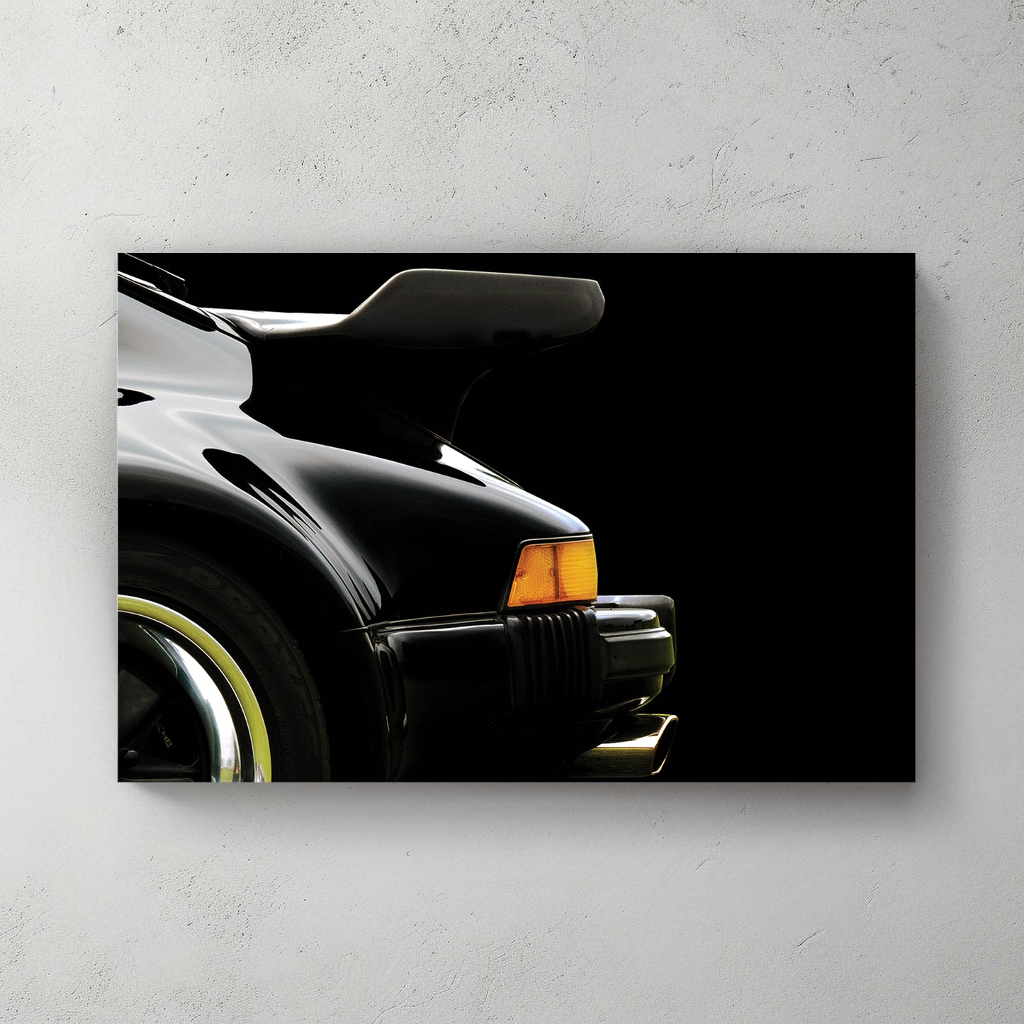 Black Porsche 911 930 Turbo rear whale-tail wing and flared fender, amber marker, black backdrop — canvas wall art print