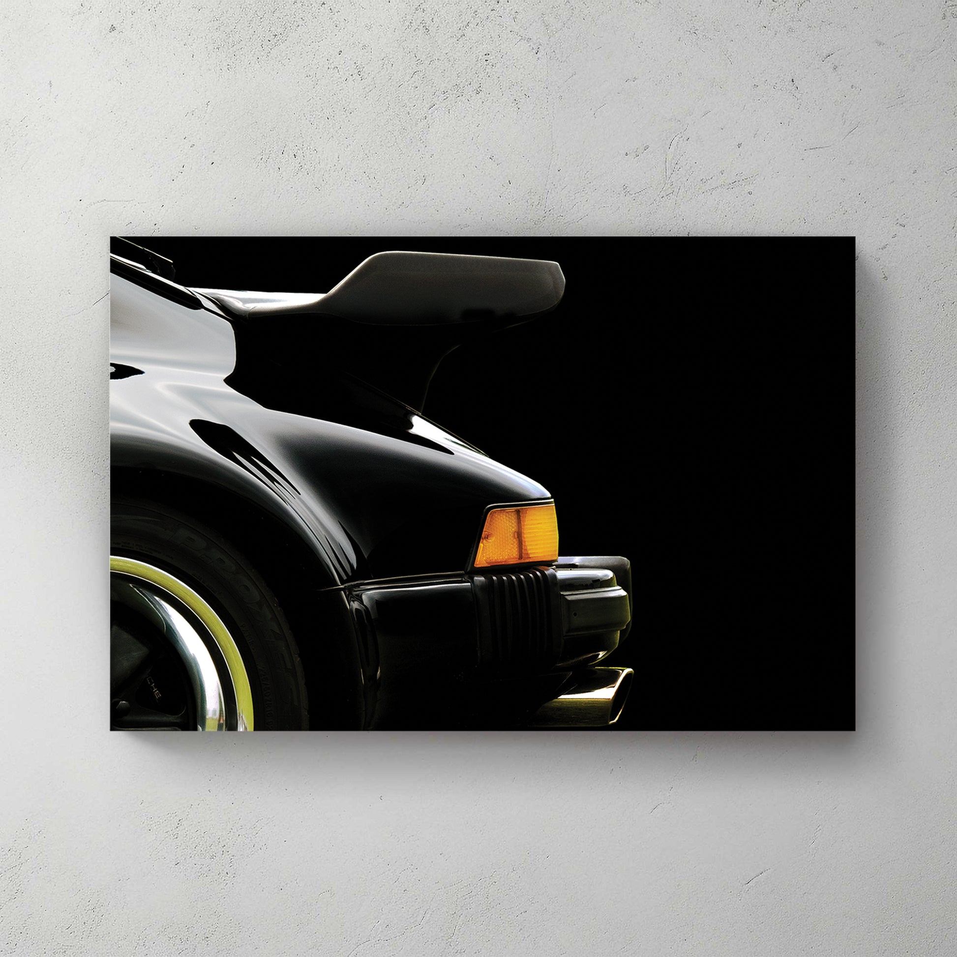 Black Porsche 911 930 Turbo rear whale-tail wing and flared fender, amber marker, black backdrop — canvas wall art print
