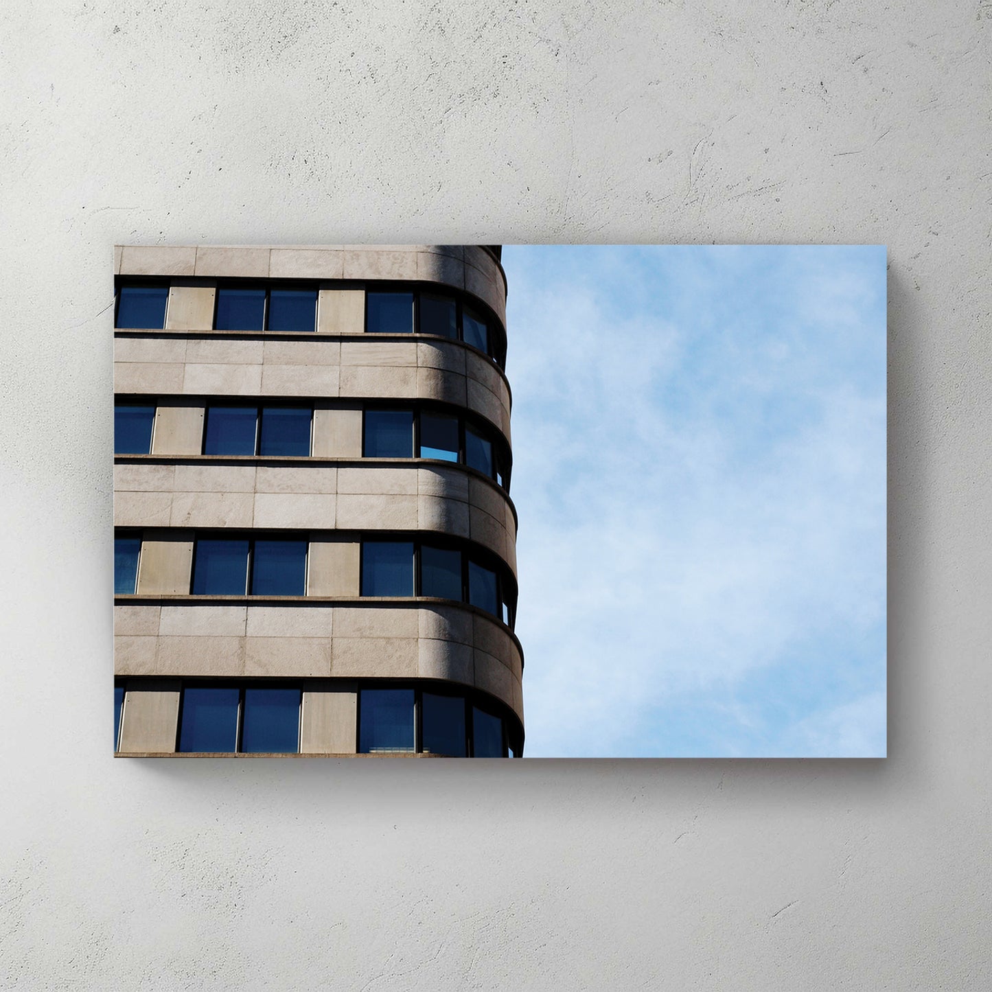 Curved modernist office tower, ribbon of windows wrapping the corner against a bright blue sky — canvas wall art print
