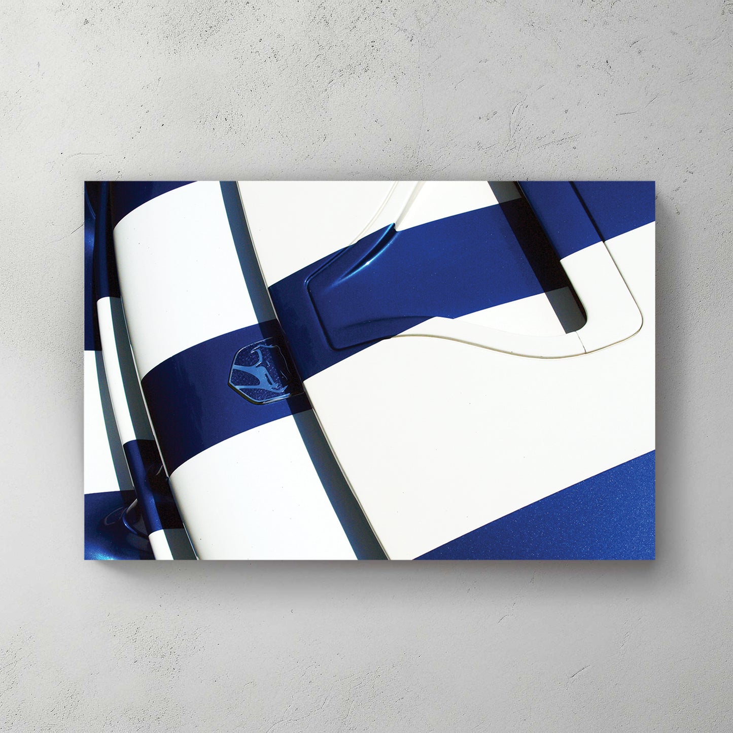 Overhead of a blue Viper hood with white stripes and viper badge, hard sunlight and deep shadow — canvas wall art print