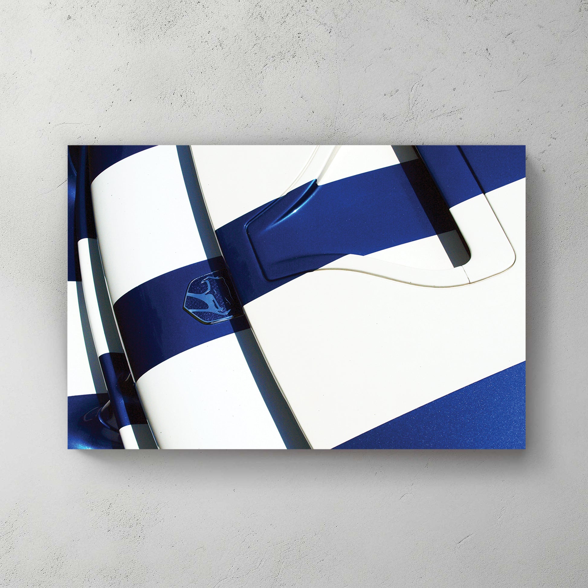 Overhead of a blue Viper hood with white stripes and viper badge, hard sunlight and deep shadow — canvas wall art print