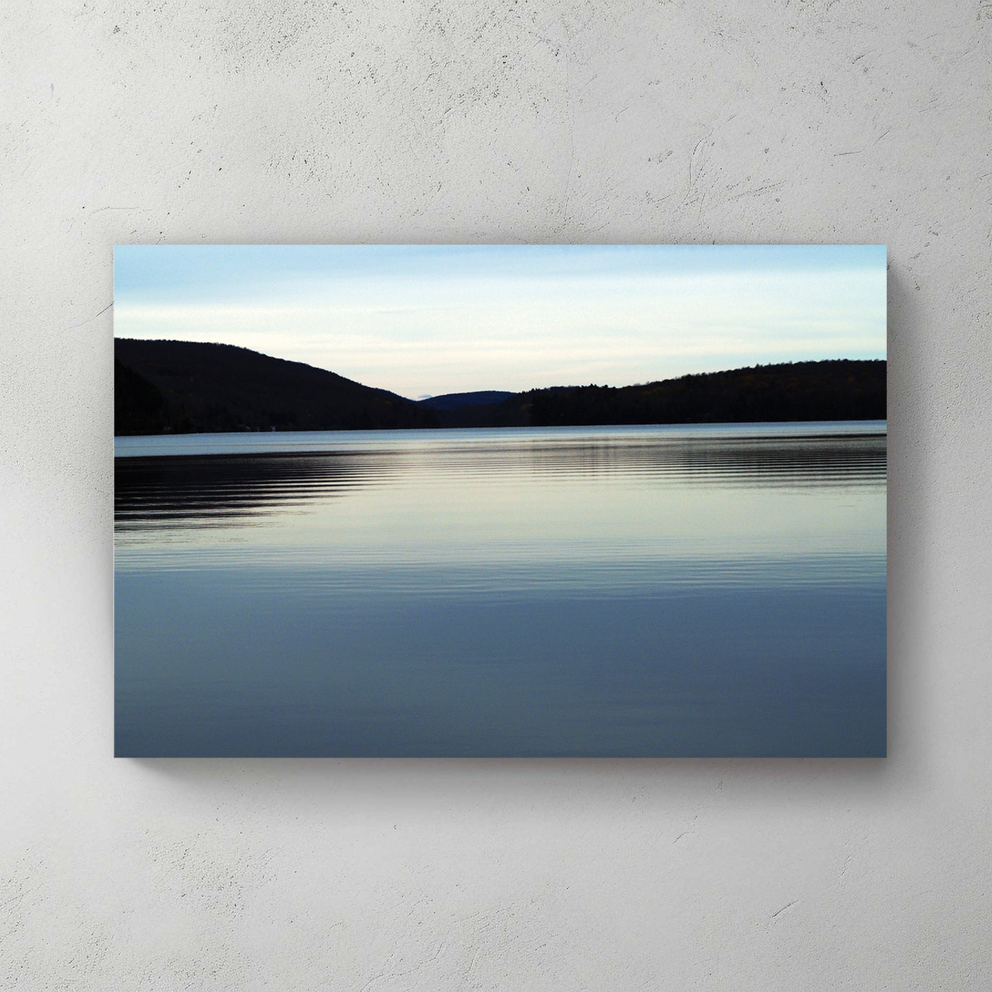 Calm blue lake at dusk, rolling forested hills on the horizon under a soft pastel sky — canvas wall art print