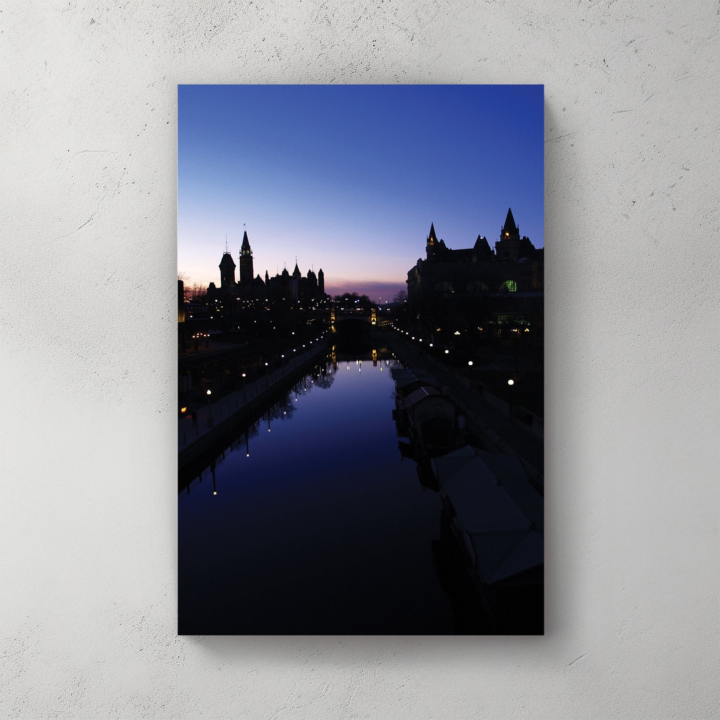 Ottawa skyline at blue hour, Parliament and Chateau Laurier silhouetted over the lamplit Rideau Canal — canvas wall art print