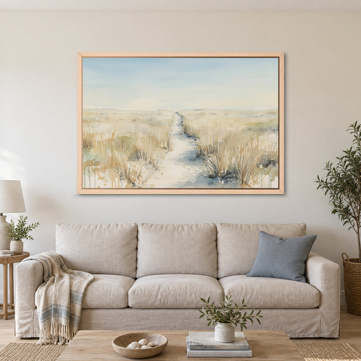 Sandy Dune Path Coastal framed canvas in a natural wood floating frame above a linen sofa with a blue cushion