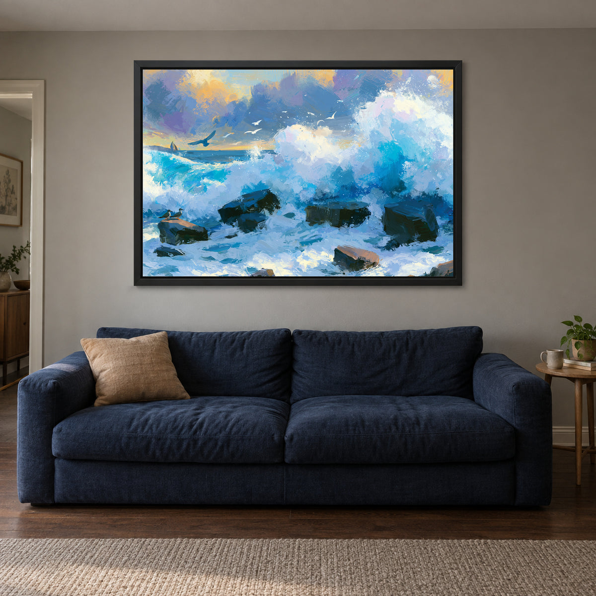 Crashing Ocean Waves Gold Sunset framed canvas in a black floating frame above a navy sofa