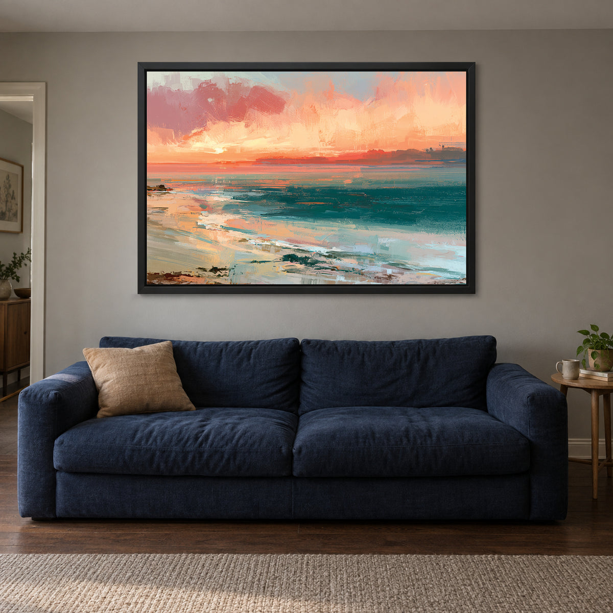 Curving Shoreline Sunset framed canvas in a black floating frame above a navy sofa