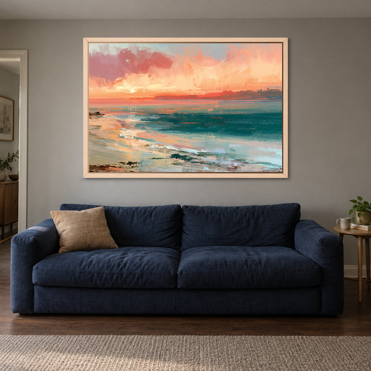 Curving Shoreline Sunset framed canvas in a natural wood floating frame above a navy sofa
