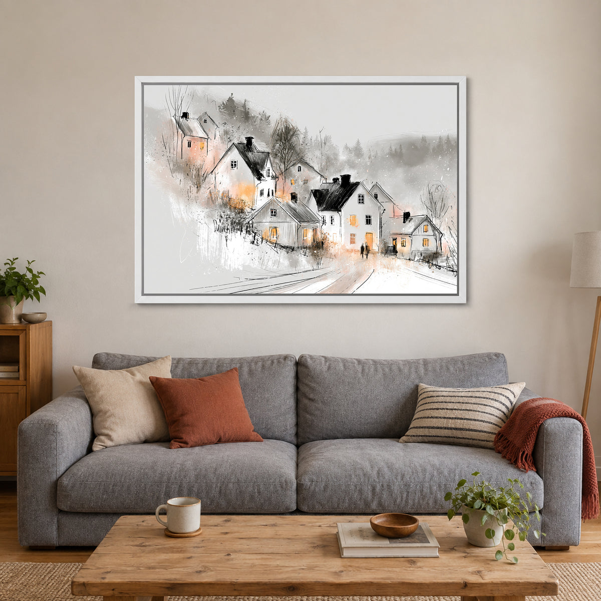 Finland Winter Dusk Cottages framed canvas in a white floating frame above a grey sofa with rust and striped cushions