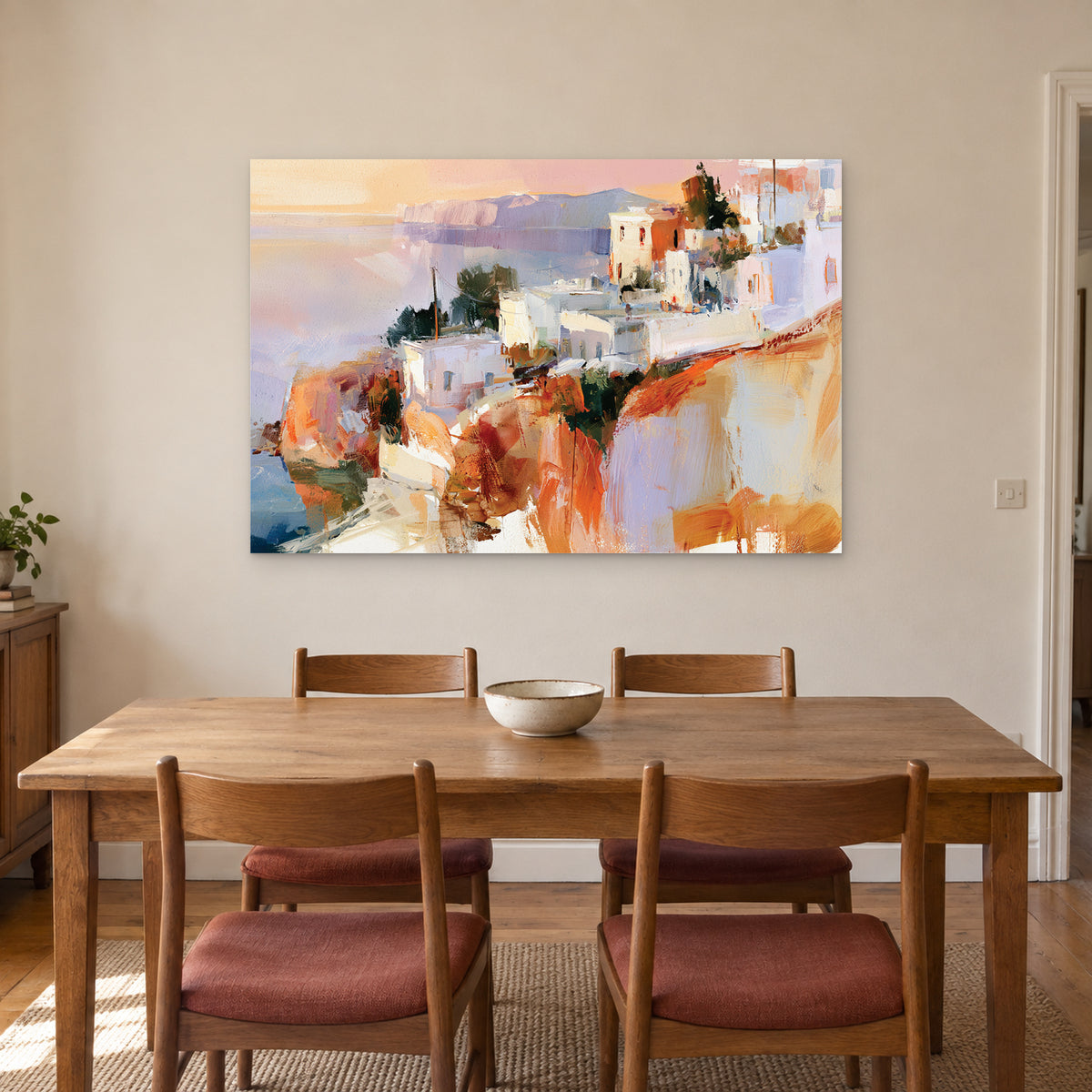 Greek Island Cliff Town canvas wall art above a wooden dining table with rust-cushioned chairs