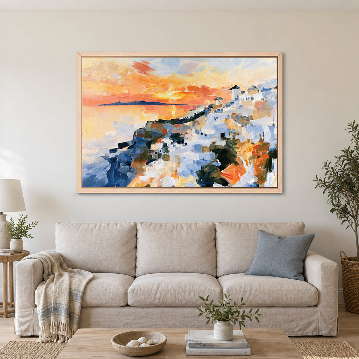 Greek Island Windmills Sunset framed canvas in a natural wood floating frame above a linen sofa with a blue cushion