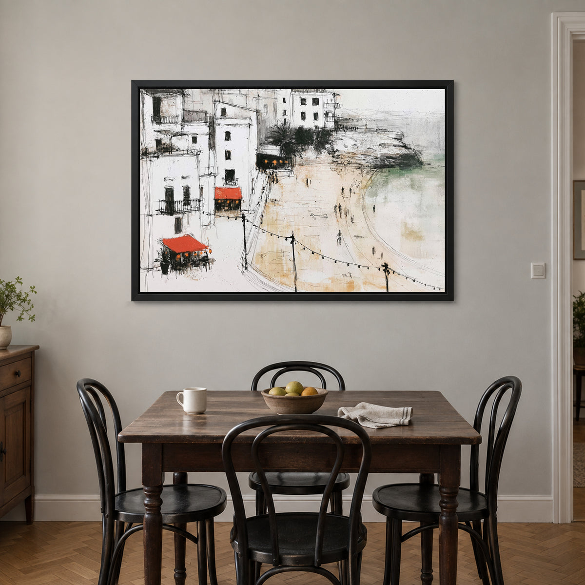 Mediterranean Promenade Lights framed canvas in a black floating frame above a small wooden dining table with black bentwood chairs